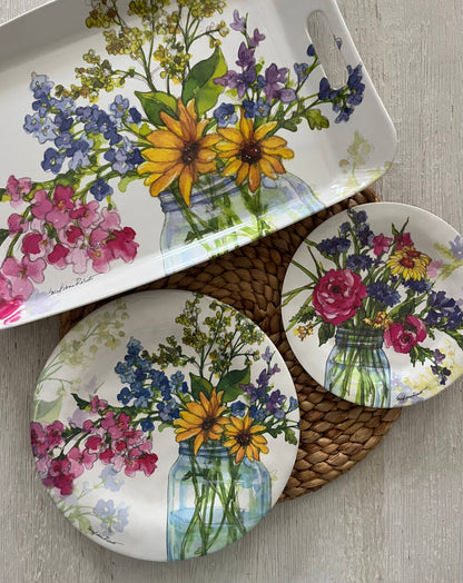 Dish set with floral design on a wooden surface