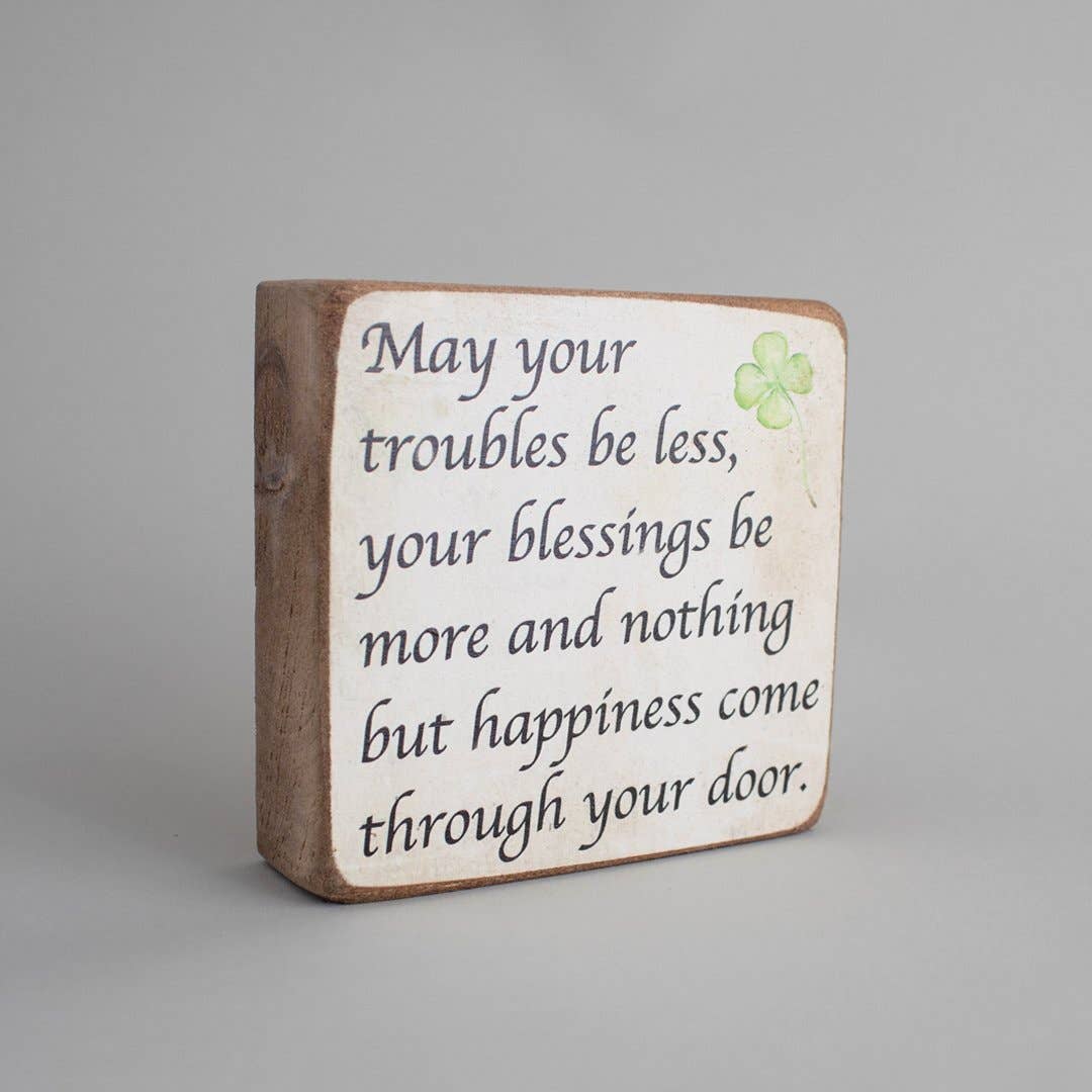 Wooden block with inspirational quote on a gray background