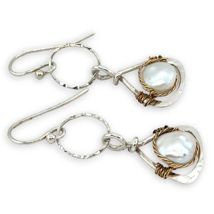 Pair of earrings with pearls on a white background