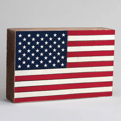 Wooden block with American flag design on a gray background