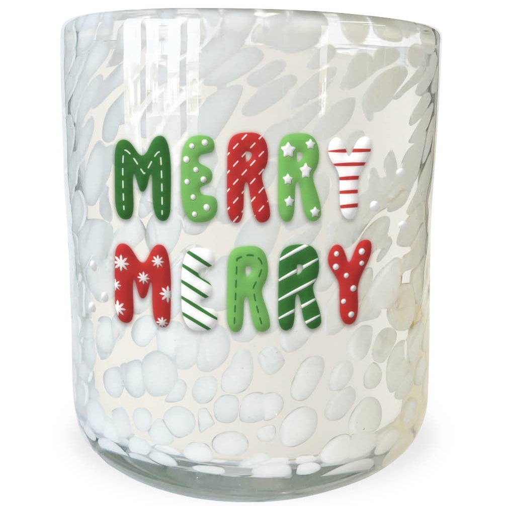 A clear glass candle jar with a white bubbly textured pattern, featuring the words 'MERRY MERRY' in festive red, green, and white holiday lettering on the front.