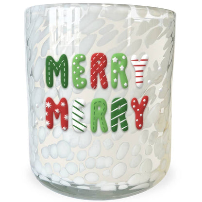 A clear glass candle jar with a white bubbly textured pattern, featuring the words 'MERRY MERRY' in festive red, green, and white holiday lettering on the front.