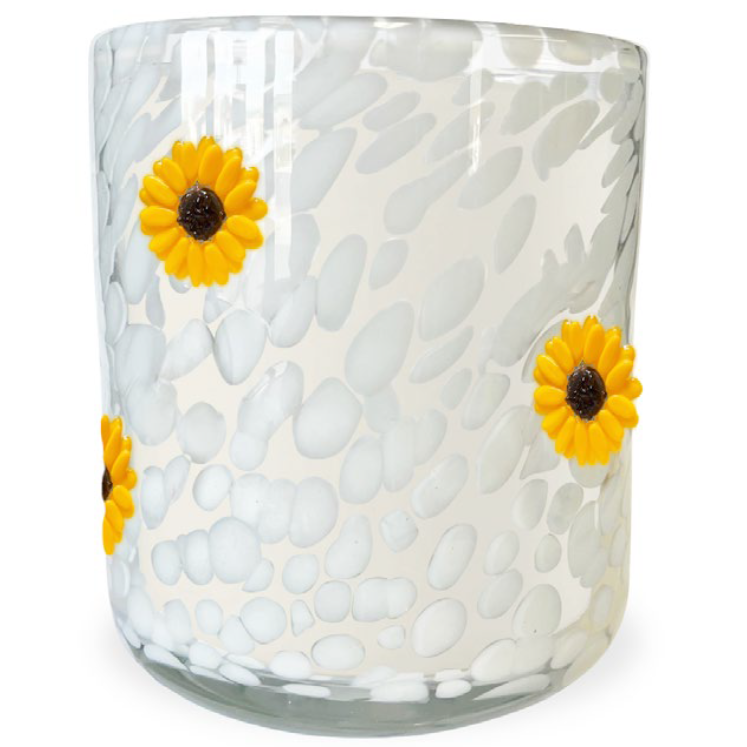 Glass candle with textured white surface and yellow sunflower designs on a white background