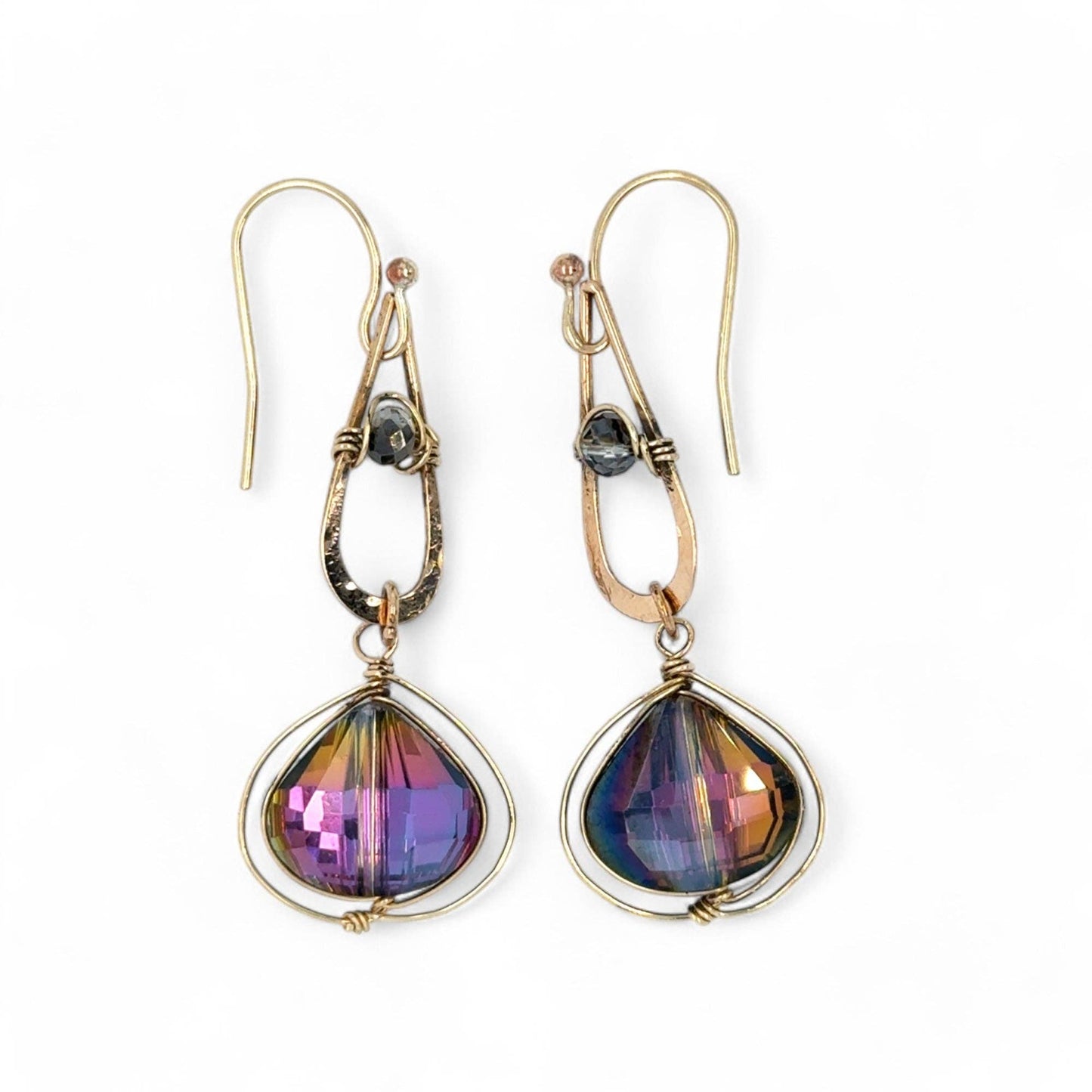 Pair of earrings with teardrop-shaped multicolored stones on a white background