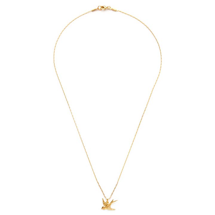 Gold necklace with a small pendant on a white background