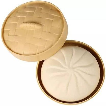Open beige container with a textured lid on a white background