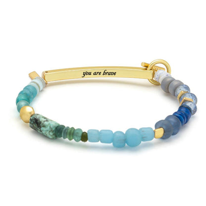 Bracelet with beads and gold clasp on a white background