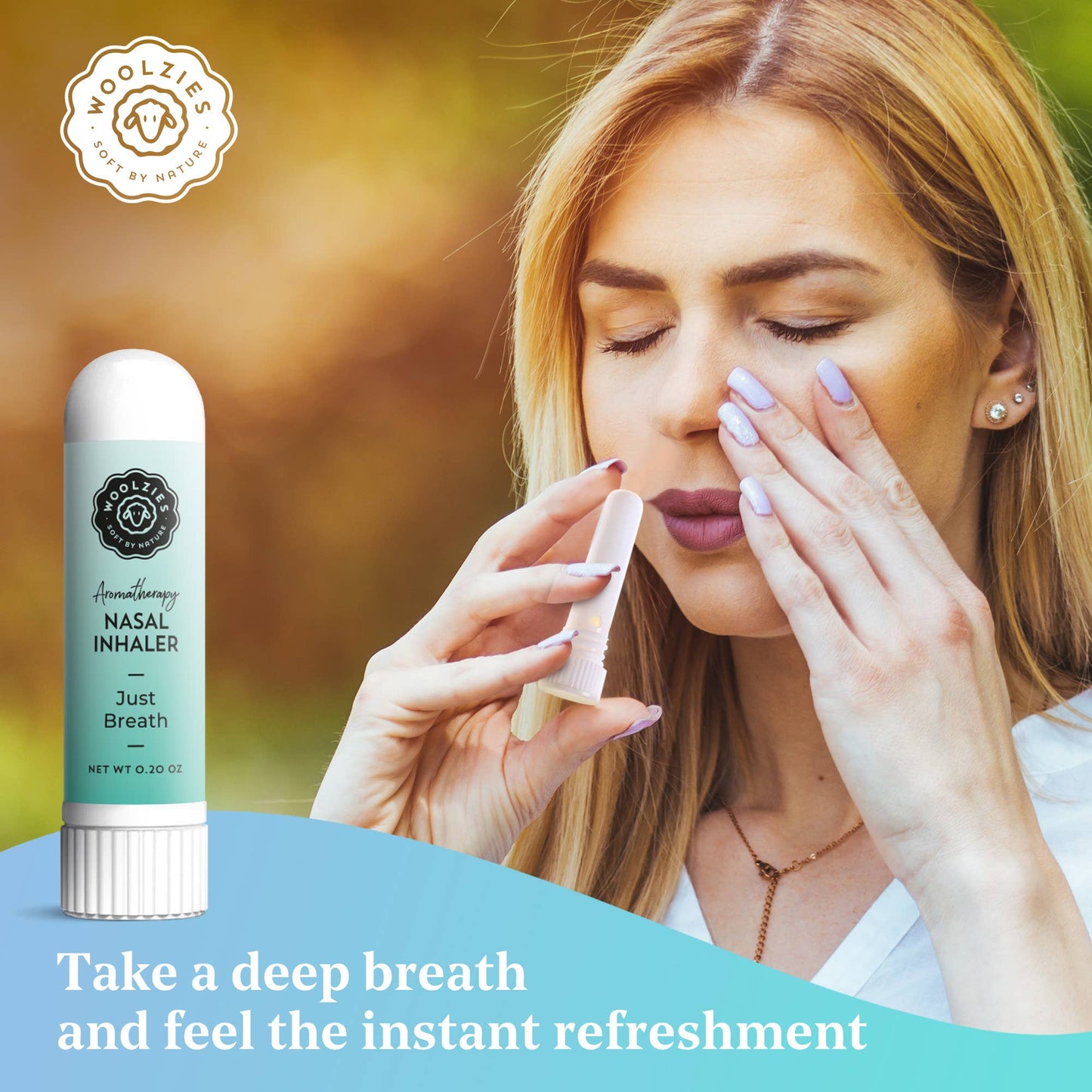 Woman using a nasal inhaler with a blurred outdoor background, featuring Woolzies brand.