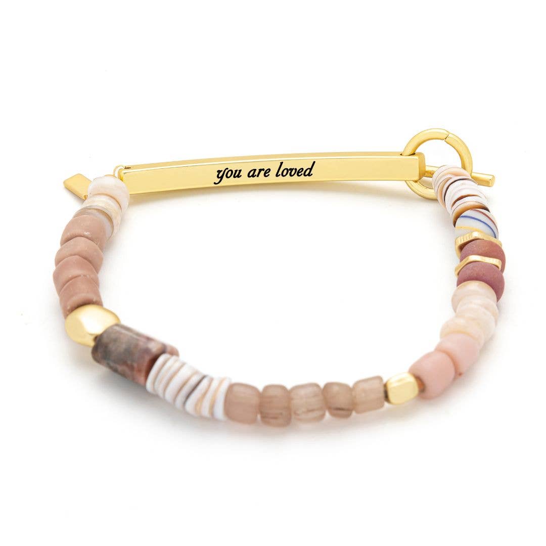 Bracelet with multicolored beads and gold clasp on a white background