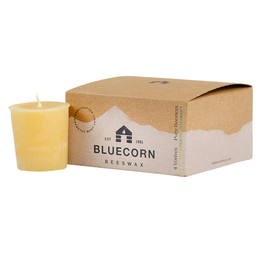 Beeswax votive candle next to a cardboard box with 'Bluecorn' branding on a white background