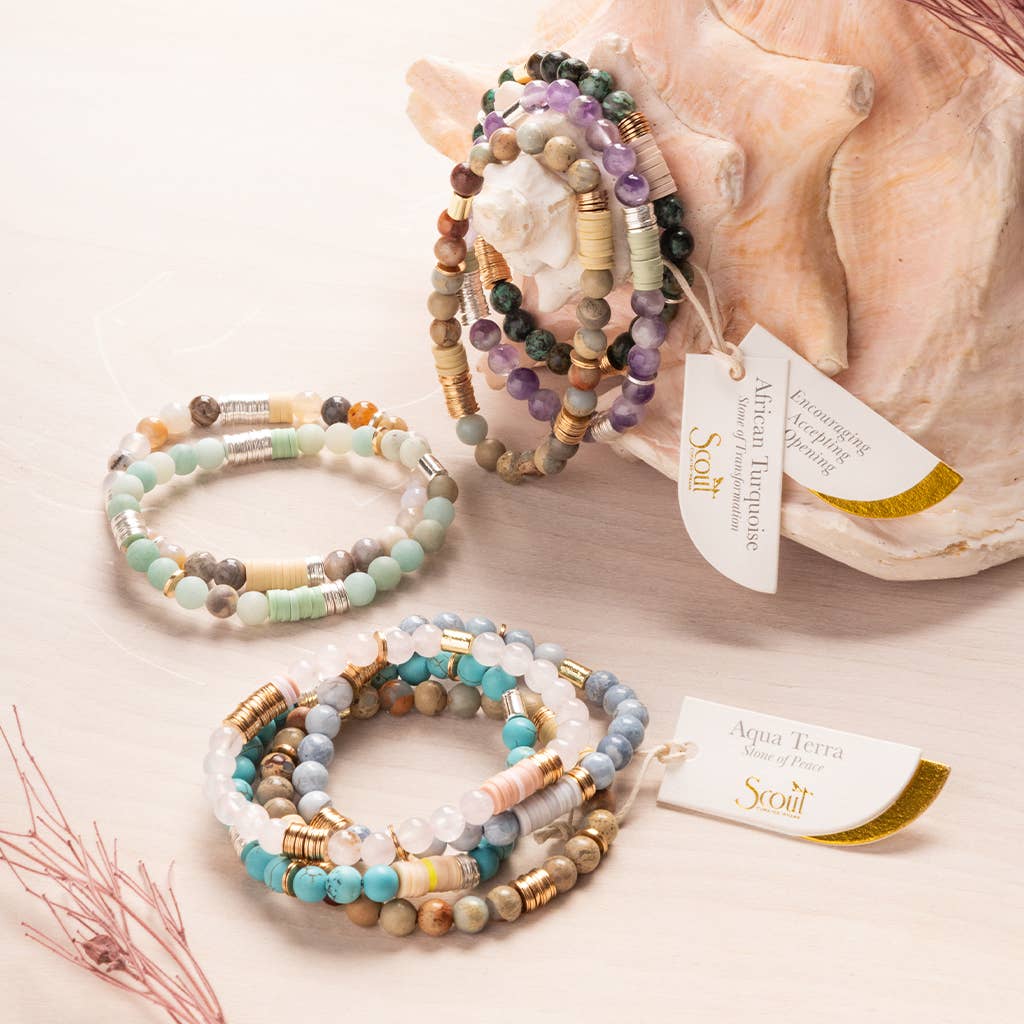 Set of beaded bracelets with tags on a light background