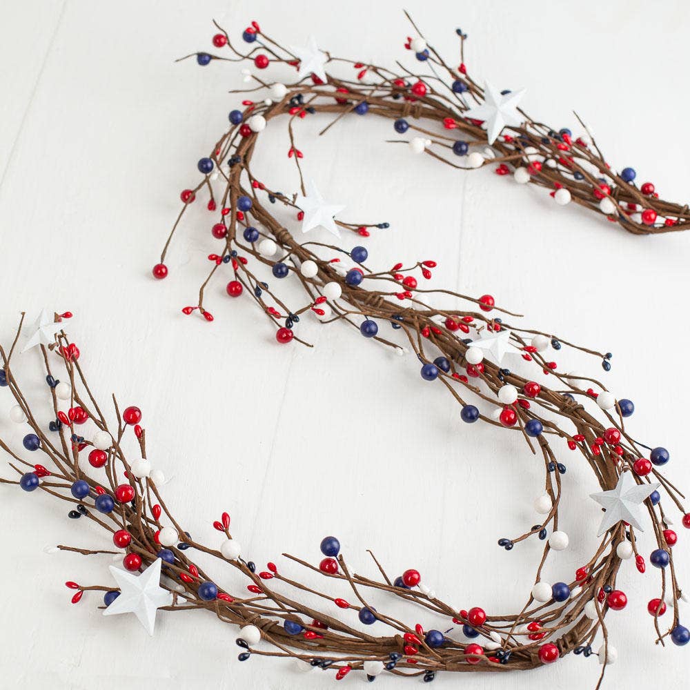 Decorative garland with red, white, and blue berries on a white background