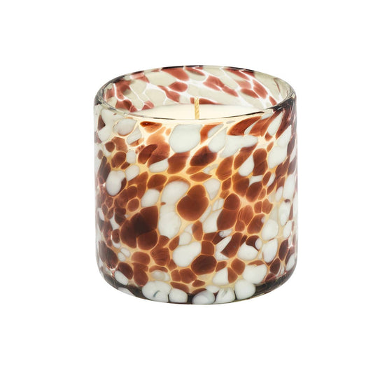 Candle in a glass container with a marbled pattern on a white background