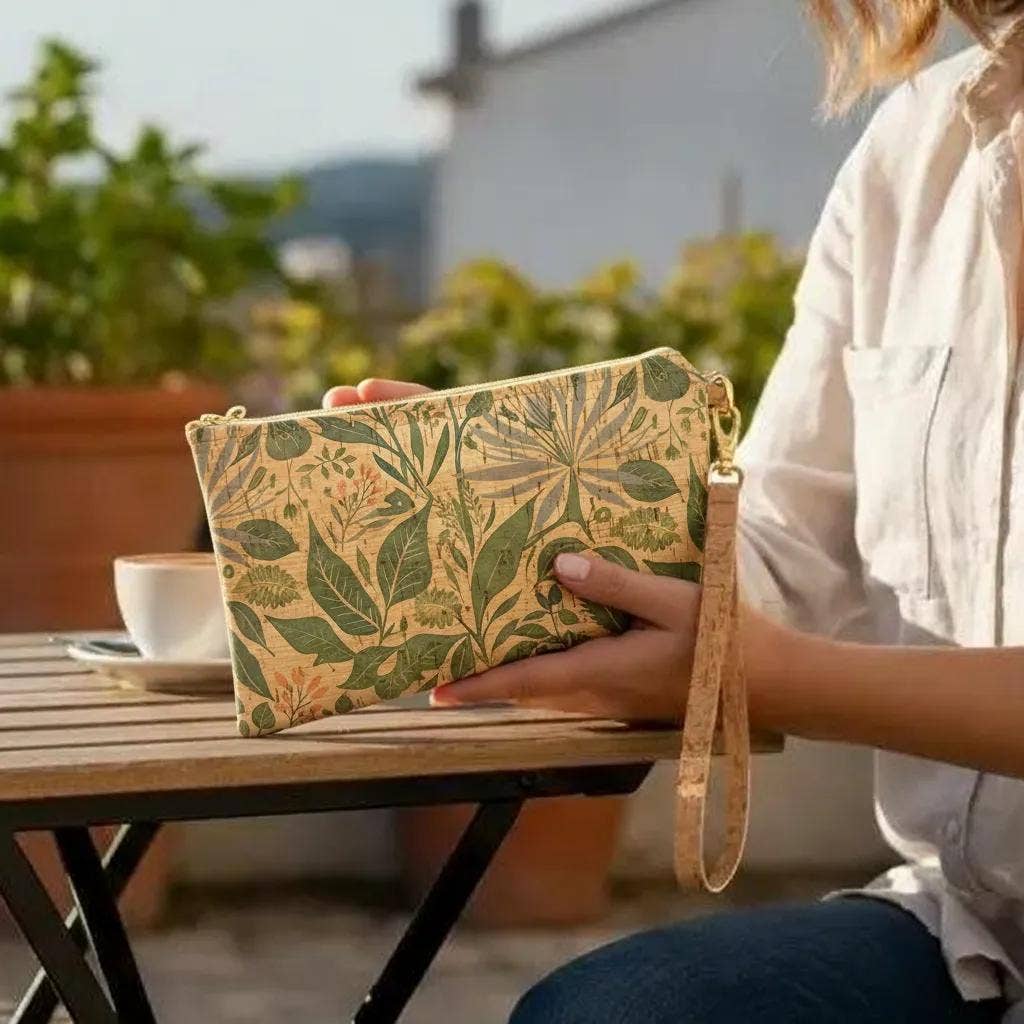 Person holding a leaf-patterned clutch outdoors