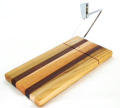 Wooden cutting board with a cheese slicing wire photographed on a white background.
