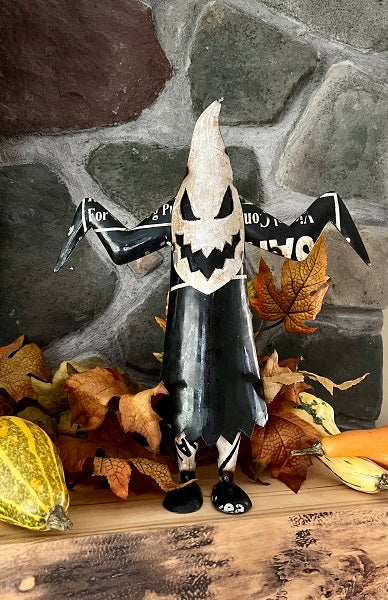 Halloween-themed decoration with a ghost jack-o'-lantern design on a stone wall background.