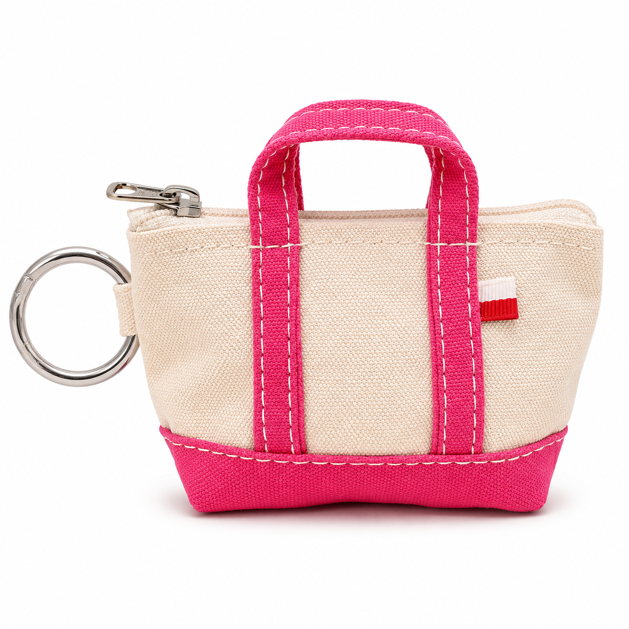 Small beige bag with pink handles and trim, attached to a keychain on a white background