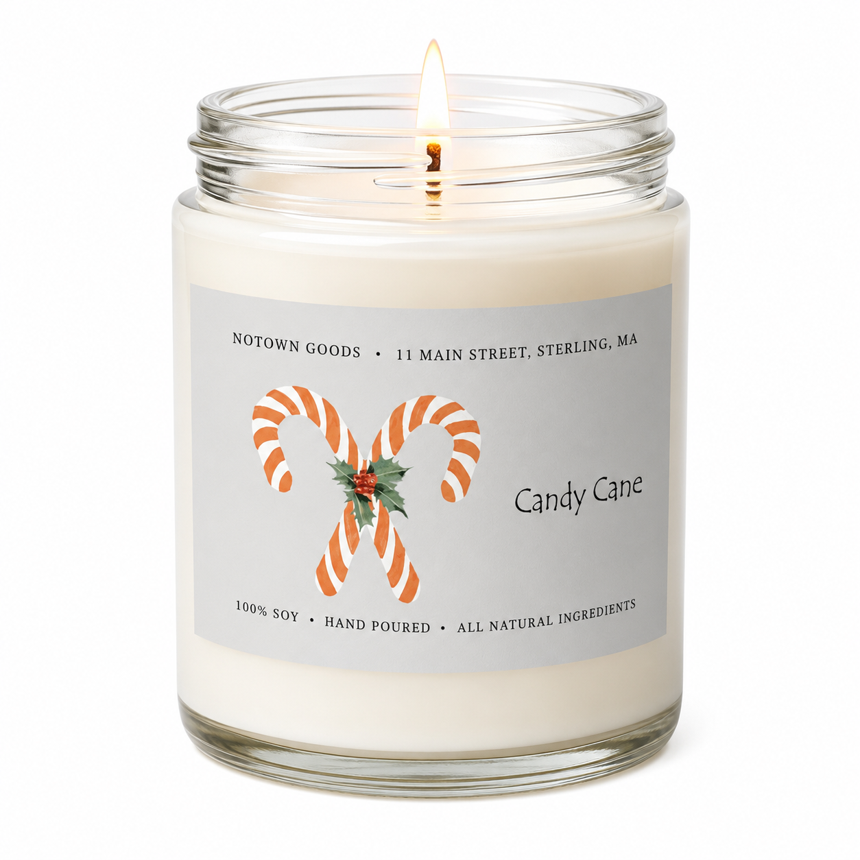 Clear jar candle with white wax and a decorative label on a white background.