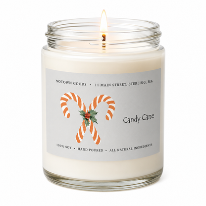 Clear jar candle with white wax and a decorative label on a white background.