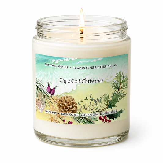 Clear jar candle with white wax and a decorative label on a white background.