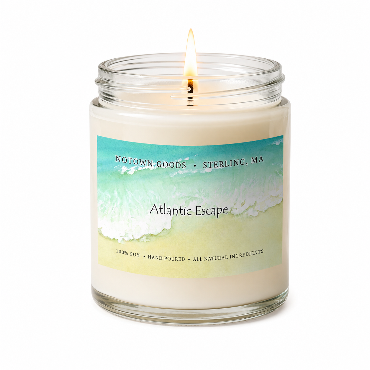 Clear jar candle with white wax and a decorative label on a white background.