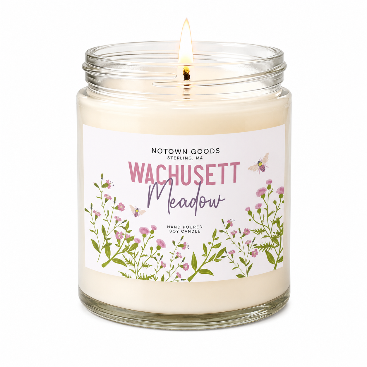 Clear jar candle with white wax and a decorative label on a white background.