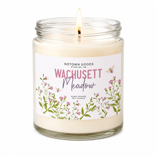 Clear jar candle with white wax and a decorative label on a white background.