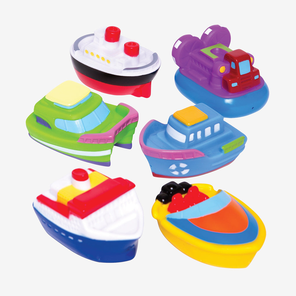 Set of colorful toy boats on a white background