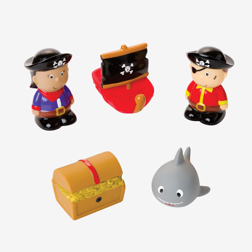 Set of pirate-themed toys including a boy, a ship, a treasure chest, and a shark on a white background.