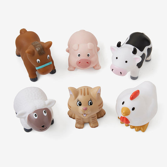 Set of six farm animal toys on a white background