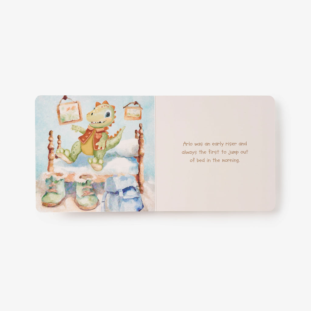 Children's book open to a page with a dragon illustration and text on a white background