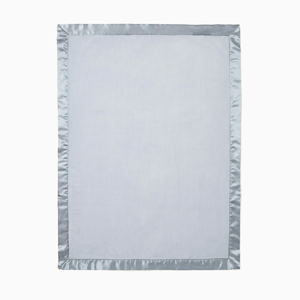 Light blue blanket with a textured border on a white background