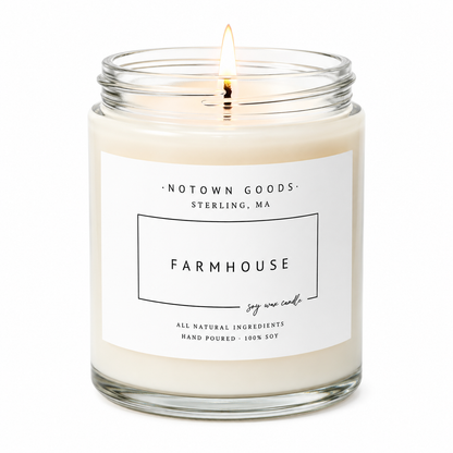 Clear jar candle with white wax and a decorative label on a white background.