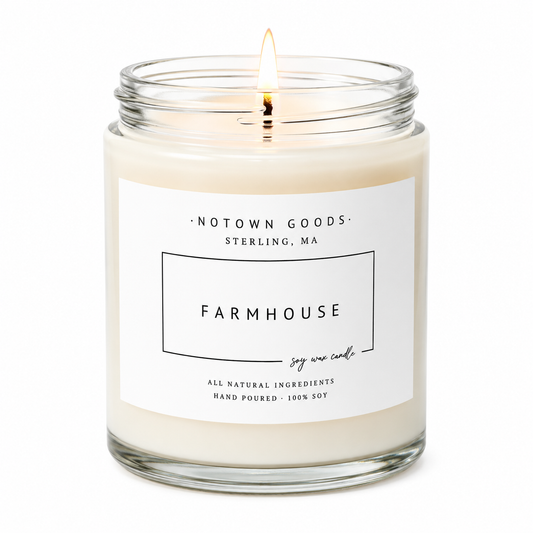Clear jar candle with white wax and a decorative label on a white background.