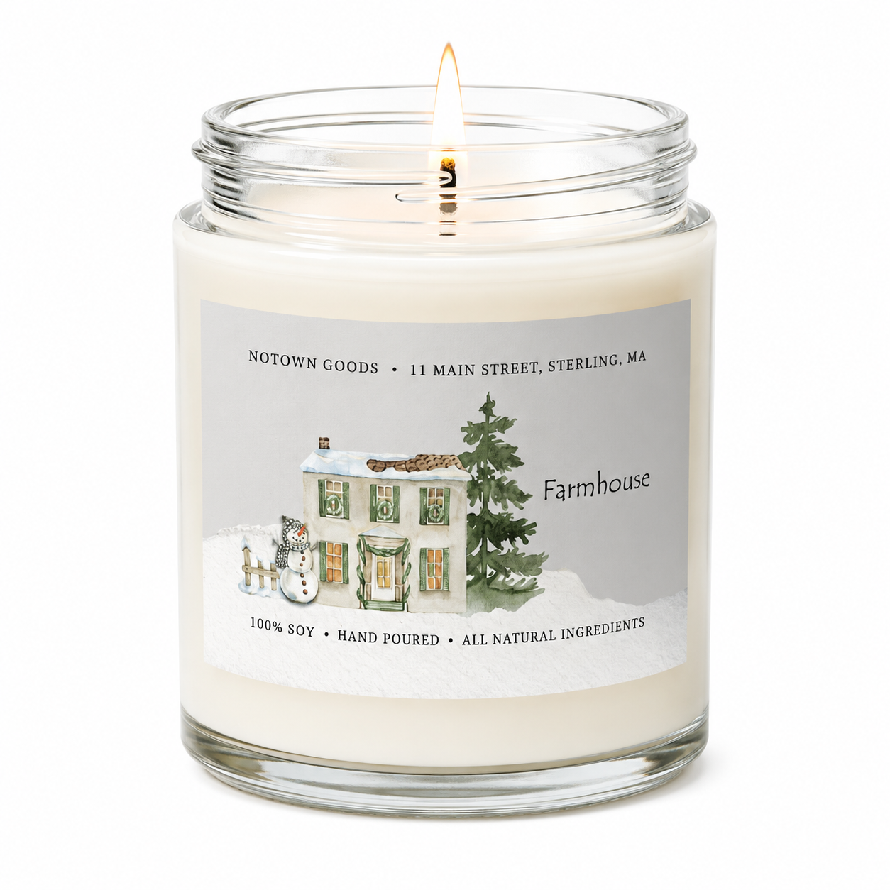 Clear jar candle with white wax and a decorative label on a white background.