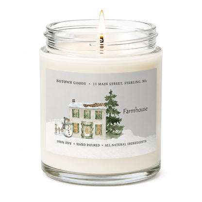 Clear jar candle with white wax and a decorative label on a white background.