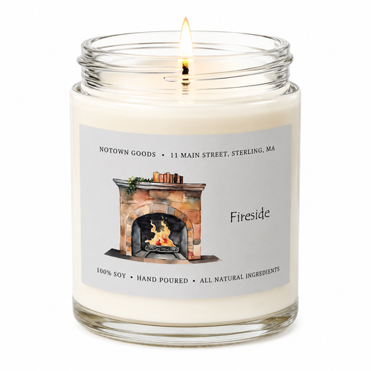 Clear jar candle with white wax and a decorative label on a white background.