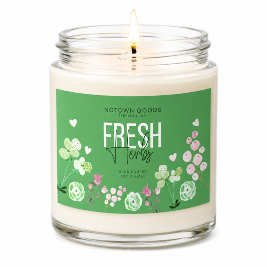 Clear jar candle with white wax and a decorative label on a white background.