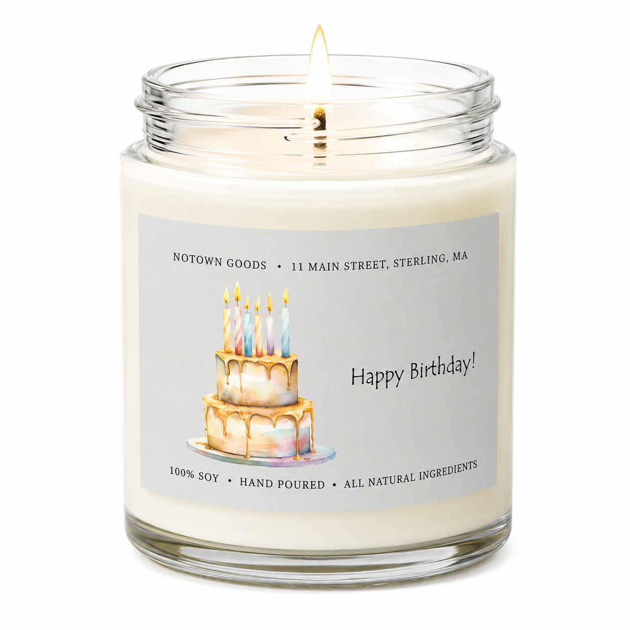 Clear jar candle with white wax and a decorative label on a white background.