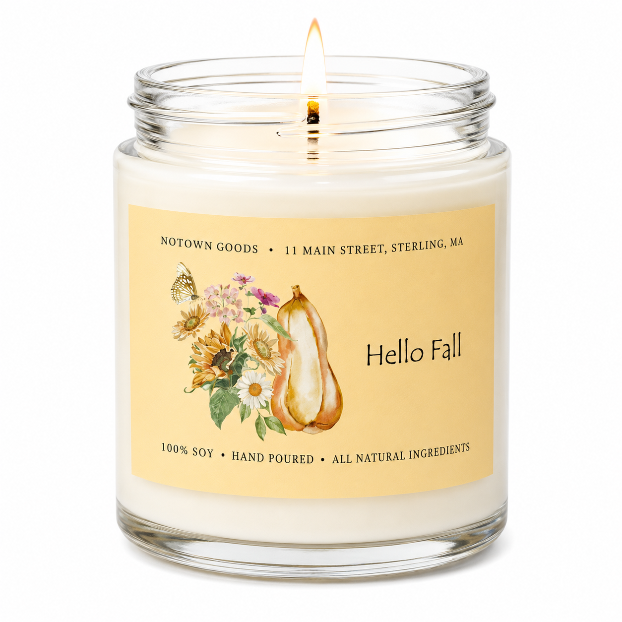Clear jar candle with white wax and a decorative label on a white background.