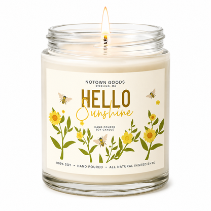 Clear jar candle with white wax and a decorative label on a white background.