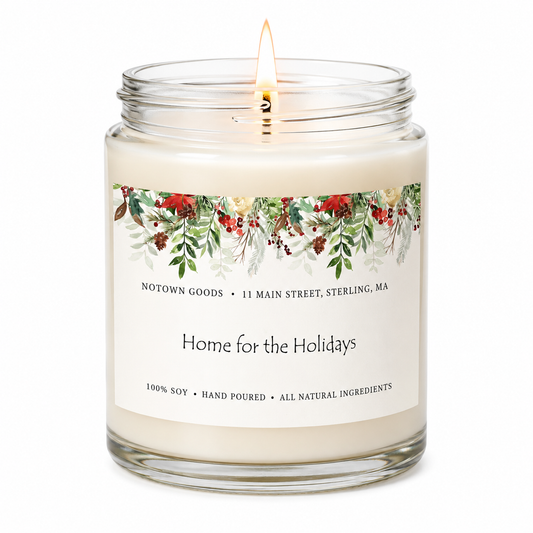 Clear jar candle with white wax and a decorative label on a white background.