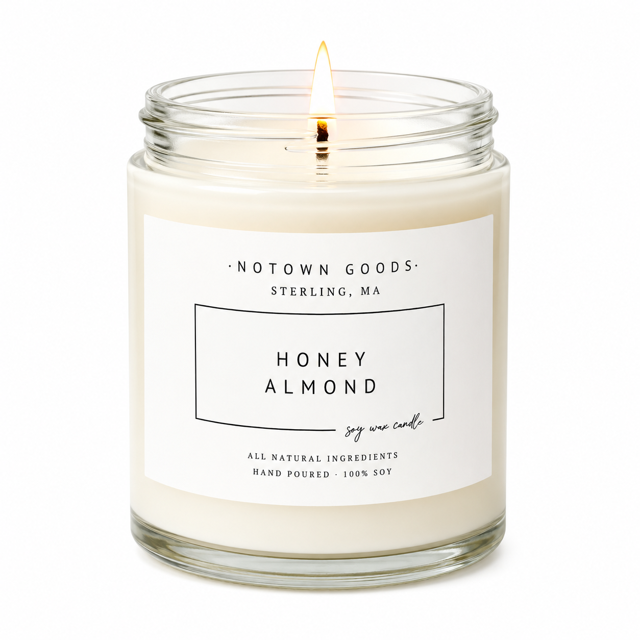 Clear jar candle with white wax and a decorative label on a white background.