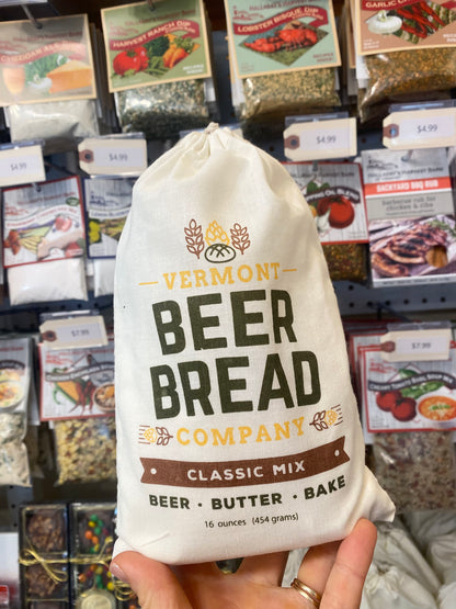 Bag of Vermont Beer Bread Company classic mix held in front of a store shelf with various products.