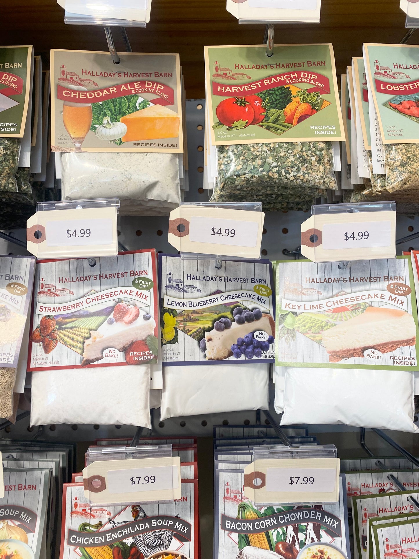 Display of Halladay's Harvest Barn food mixes including dip, cheesecake mix, and soup mix with price tags.