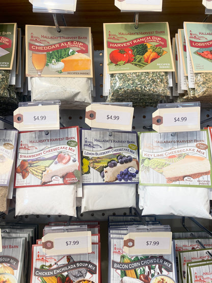 Display of Halladay's Harvest Barn food mixes including dip, cheesecake mix, and soup mix with price tags.