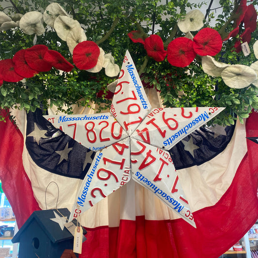 Decorative star with Massachusetts license plates and American flag background.