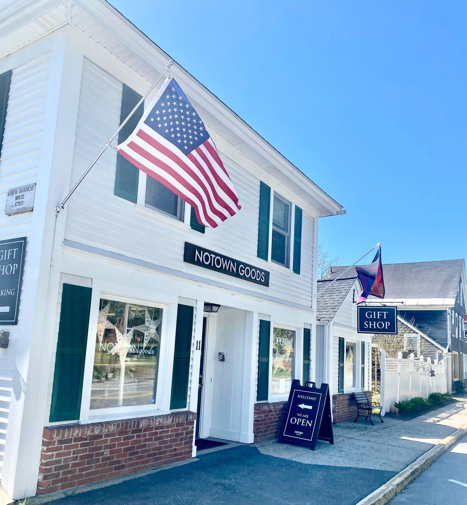 Storefront with 'Notown Goods' sign and American flag on a clear day