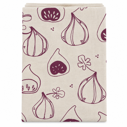 A cream colored tea towel with fig design printed in burgundy on a white background.
