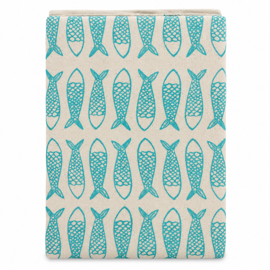A cream colored tea towel with fish design printed in turquoise blue on a white background.
